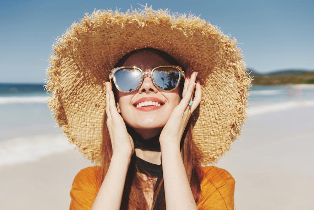 Woman With Sunglasses Facing The Sun