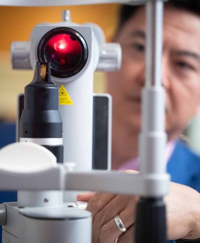 Doctor Using Equipment For Eye Check Up — Ophthalmologist In Southport, QLD